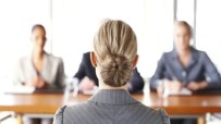 Professional job interview setting with diverse candidates seated at a table, highlighting workplace diversity and inclusion.