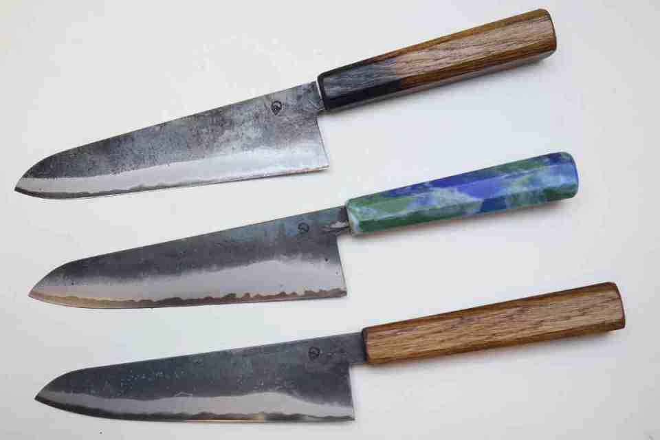 Christmas gifts 2025: Assorted knives displayed on a countertop, showcasing various blade styles and handles, suitable for culinary enthusiasts.