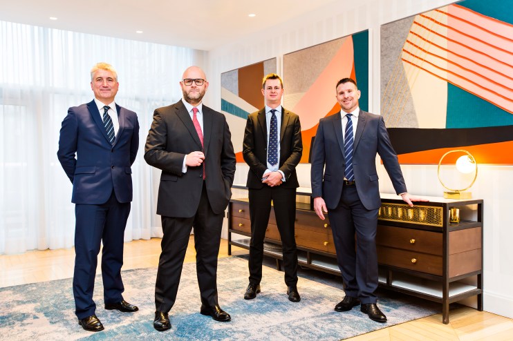 Craig Harrison, Ruben Sinha, Joe Cobb, and Thomas Pearson standing together, likely in a business or news-related setting.