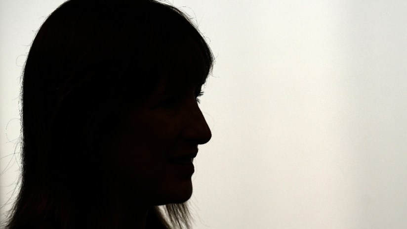 Keanu Reeves as James Bond in a sleek suit against a night cityscape for the latest Spectre film adaptation news.