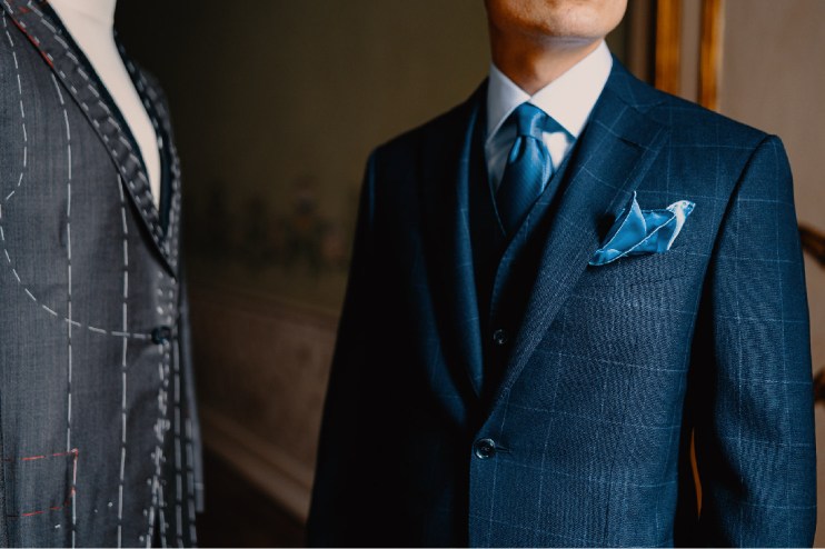 Tailored suit jacket on display at Sartoria, highlighting fine craftsmanship and elegant design in a business setting