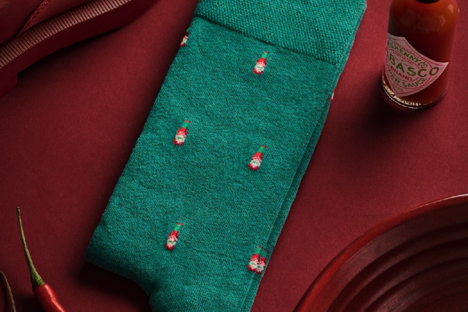 Colorful socks displayed on a wooden background, highlighting a modern design suitable for casual and business wear.