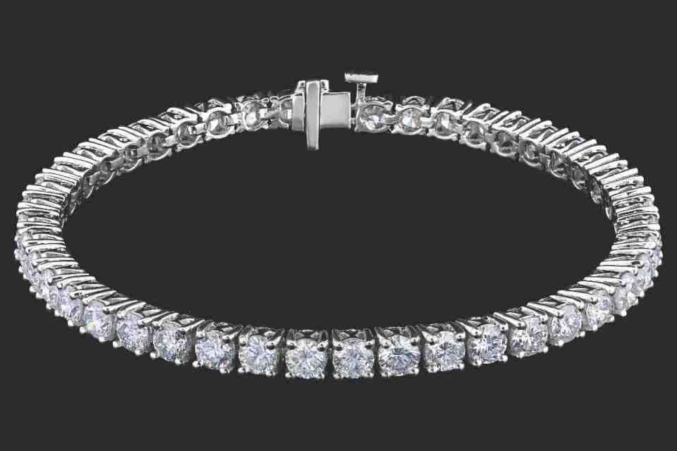 Elegant diamond tennis bracelet displayed on a white background, highlighting its sparkling stones and intricate design.