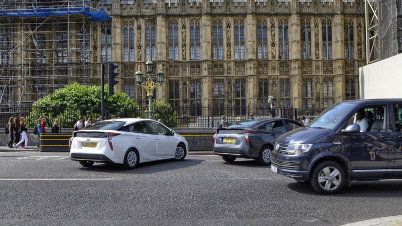 Uber Prius Bolt electric vehicles parked in a row, highlighting the companys shift towards sustainable transportation solu...