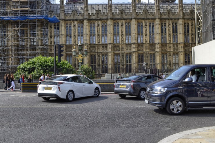 Uber Prius Bolt electric vehicles parked in a row, highlighting the companys shift towards sustainable transportation solu...