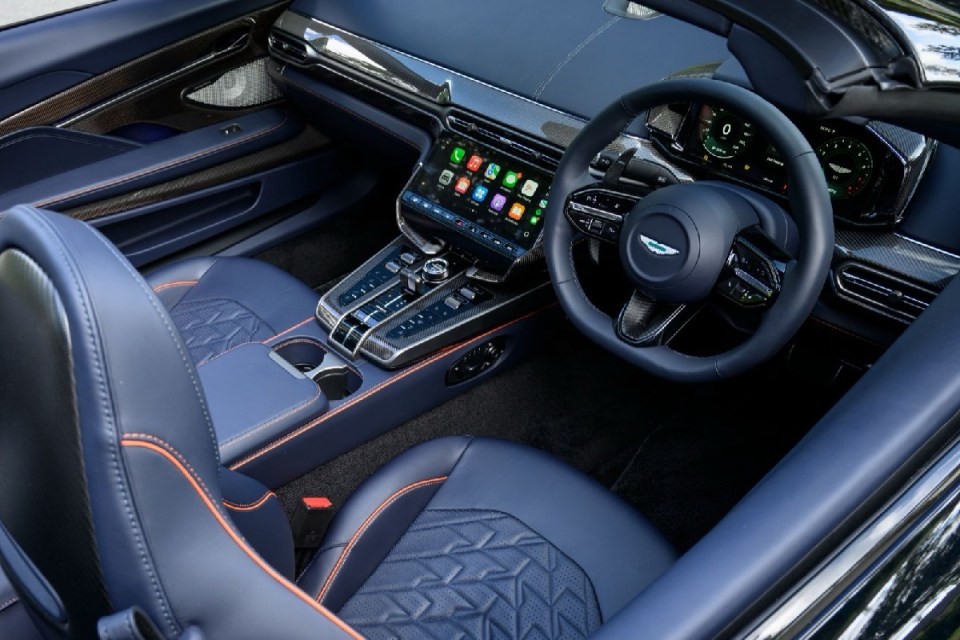 Aston Martin Vanquish 11 showcased, highlighting sleek design and luxury features, appealing to automotive enthusiasts.