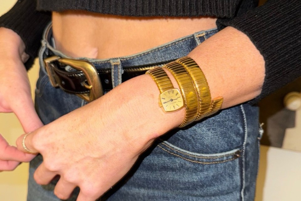 Courtney showcases exquisite watch collection, highlighting diverse luxury timepieces in a sophisticated display setting.