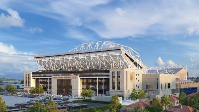 Southwest corner view showcasing modern architectural design with glass facades and bustling city street in daylight.