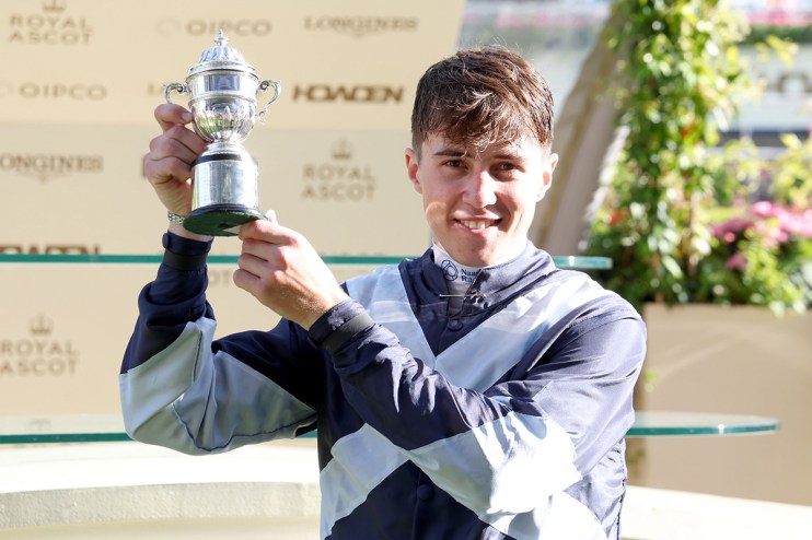 Dylan Browne McMonagle celebrates victory at a horse racing event, wearing racing gear with a jubilant expression.