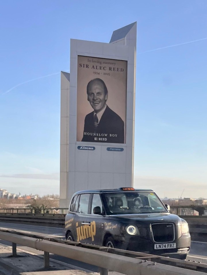 Alec Reed delivering a keynote speech at a business conference, gesturing towards the audience with a confident expression