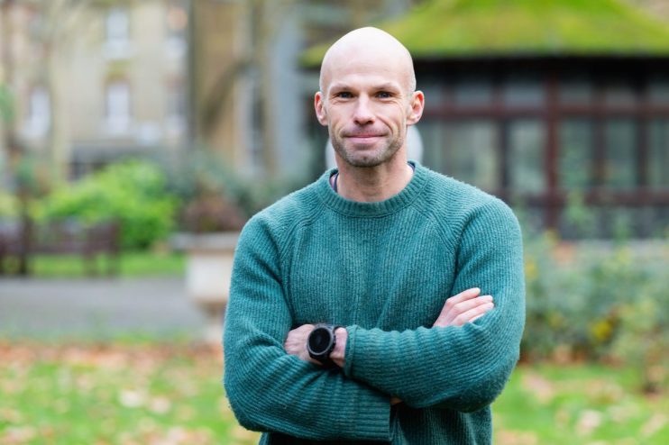 Alex Cooper, CEO of Electric Twin, delivering a keynote speech at a business conference, emphasizing innovation in technol...