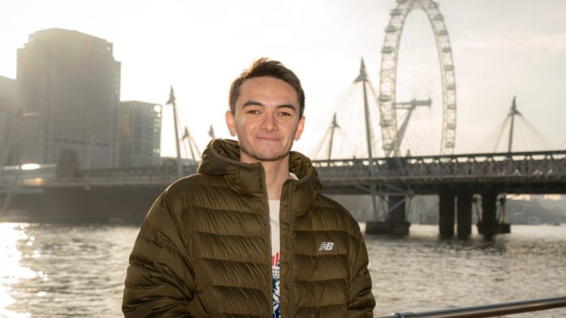 Alex Yee speaking at London T100 event promoting Olympic Triathlons return to capital, wearing athletic gear, in front of ...