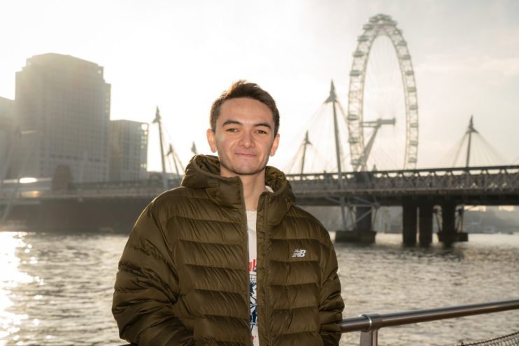 Alex Yee speaking at London T100 event promoting Olympic Triathlons return to capital, wearing athletic gear, in front of ...