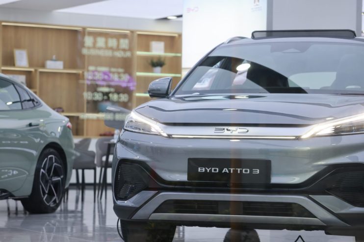 BYD electric vehicle displayed at a Chinese auto show, highlighting Chinas innovation in the EV market.