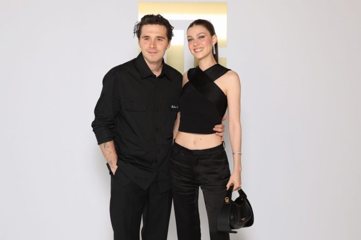 Brooklyn Beckham attending a public event in a stylish outfit, showcasing his fashion sense and celebrity presence.