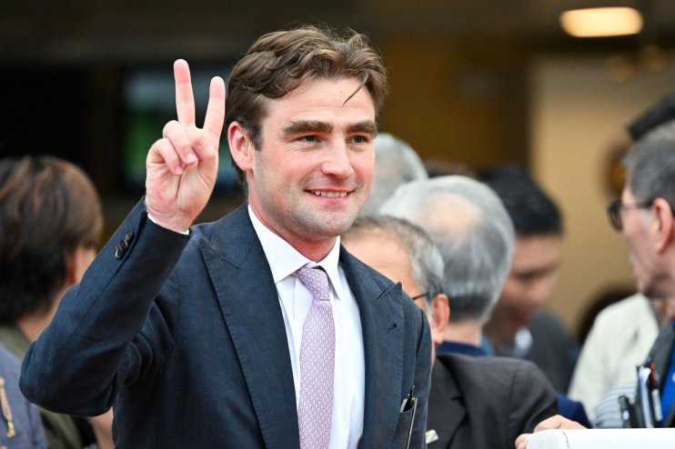 David Eustace in a professional setting, wearing business attire, engaging in a discussion about current news in the busin...