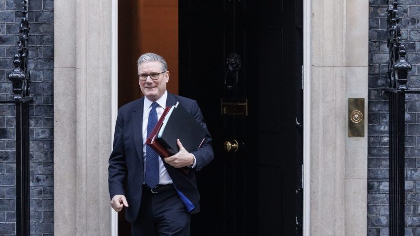 Business professionals in a boardroom engaging in a strategic discussion with charts and laptops on the table.