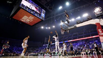 GettyImages 2256937949 showcases a dynamic business meeting with diverse professionals collaborating in a modern office se...