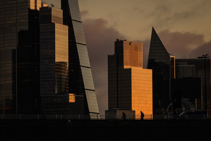 London city skyline at dawn with iconic landmarks like The Shard and Tower Bridge under a vibrant morning sky