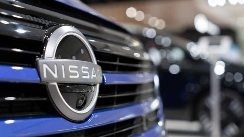 Nissan UK dealership showcasing latest car models in showroom with modern design and branding elements visible