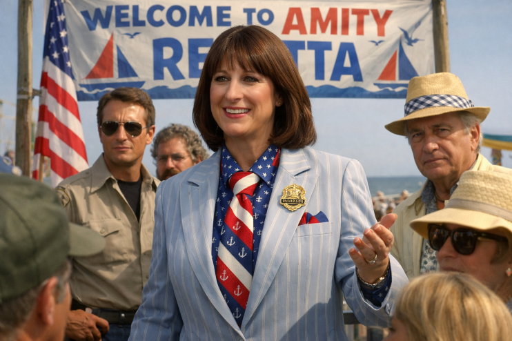 Rachel Reeves portrayed as the mayor in a Jaws-themed context, wearing a formal suit with a backdrop of the ocean.