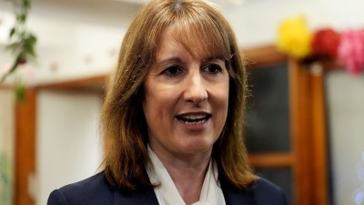 Rachel Reeves delivering a speech at a business conference, highlighting economic strategies and engaging with an audience.