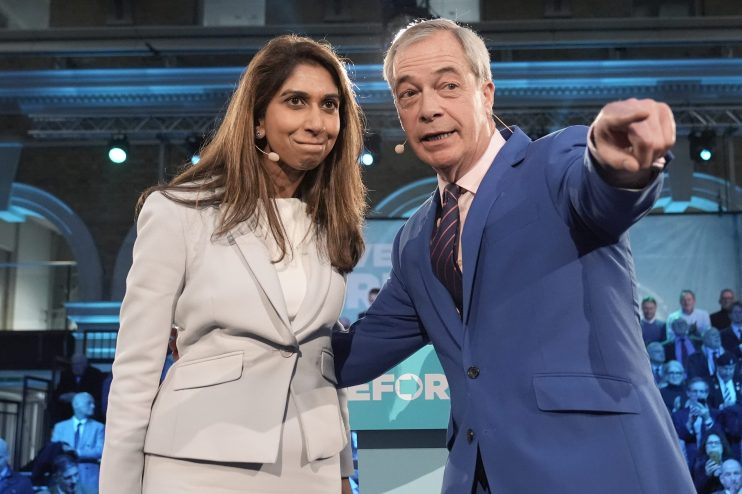 Suella Braverman and Nigel Farage in discussion at a political event, both dressed in formal attire, engaging in a serious...
