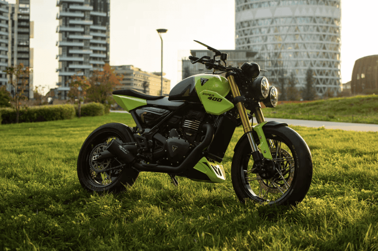 Successful business team celebrating a major achievement with smiles and raised hands in a modern corporate office setting.