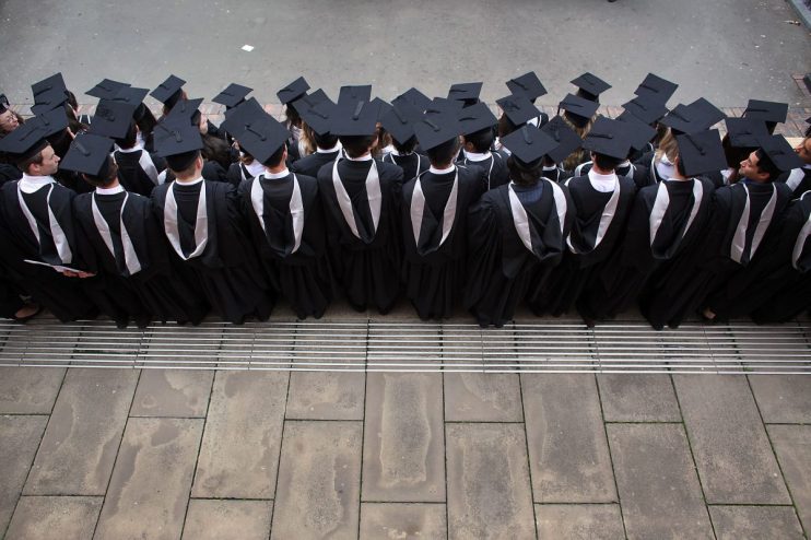 UK university graduates celebrating in caps and gowns, showcasing academic achievement and success in higher education.