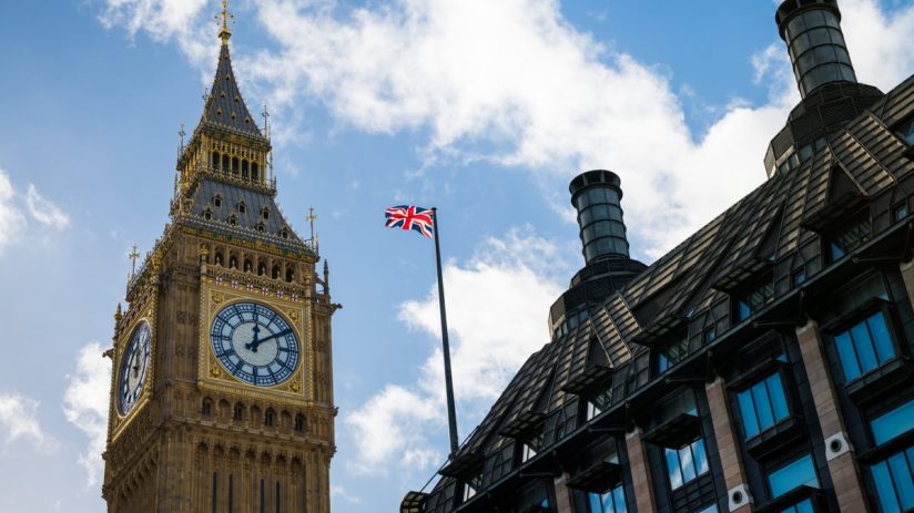 Westminster Parliament building under a cloudy sky, showcasing iconic architecture and historic significance in central Lo...