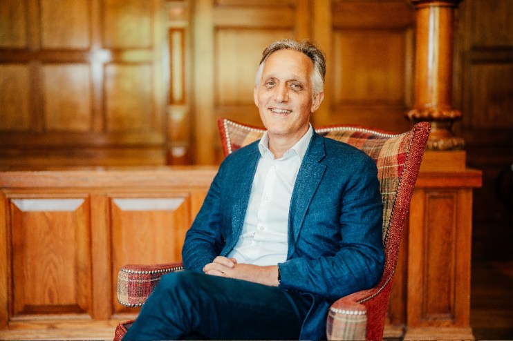 Danny Pecorelli in a business setting, discussing hospitality industry insights and leadership strategies at a conference.