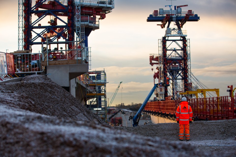 Individual holding an object, possibly related to a business or general news context, with a neutral or professional expre...