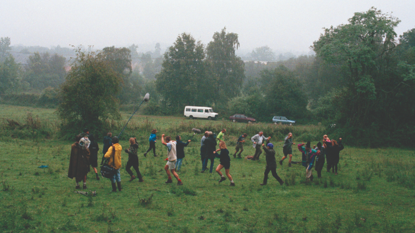 Breaking news report with a journalist at a desk, microphone, and notepad, discussing current events in a studio setting.