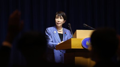 Japan Prime Minister Sanae Takaichi speaking at a press conference, highlighting her leadership and political agenda