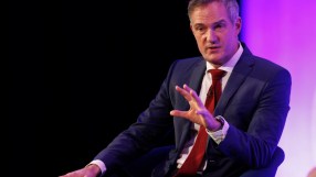 Peter Kyle speaking at a podium during a press conference, addressing current issues and developments