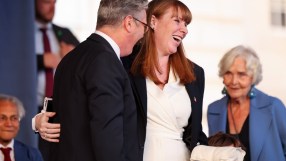 Starmer and Rayner embrace warmly, highlighting unity and camaraderie in a political setting, symbolizing partnership and ...