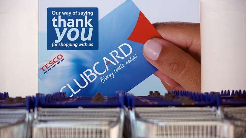Tesco Clubcard displayed on a store checkout counter, highlighting new loyalty program features and customer benefits