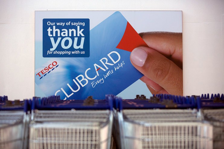 Tesco Clubcard displayed on a store checkout counter, highlighting new loyalty program features and customer benefits
