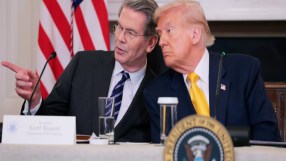 Donald Trump and Bessent in discussion at a public event, highlighting key political and business interactions