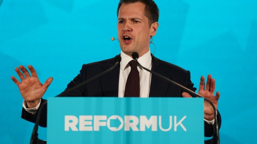 Business meeting with diverse professionals discussing a strategic plan, documents and laptops on the conference table