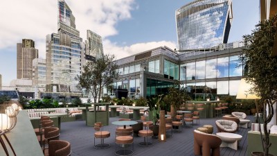 City skyline from rooftop office, showcasing modern architecture and bustling urban life on a clear day.