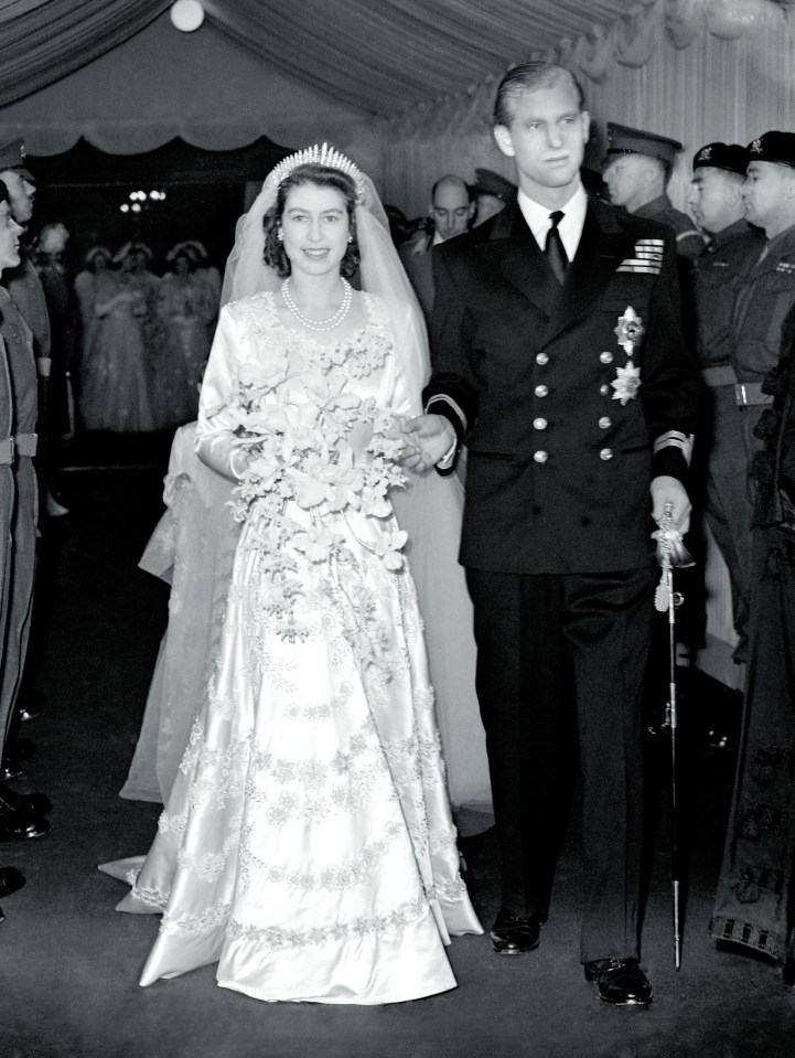 Queen Elizabeth II holding a colorful bouquet, symbolizing grace and elegance, in a formal setting.
