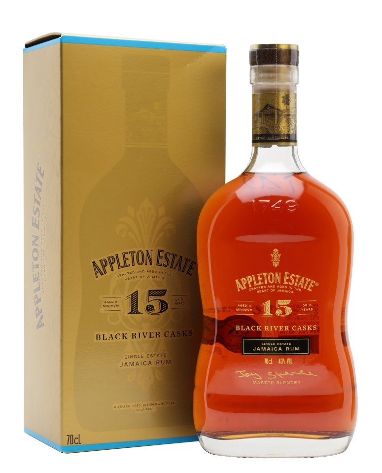 Appleton 15 Year Old rum bottle on a wooden table with a glass, highlighting premium Jamaican rum craftsmanship