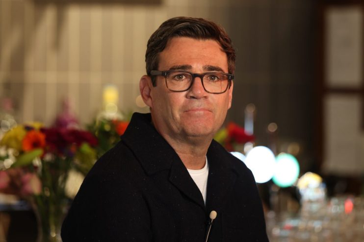 Andy Burnham speaking at a Manchester event, addressing local community issues and future development plans.