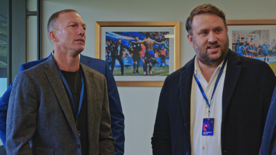 Urban skyline at sunrise with skyscrapers in silhouette, highlighting morning activity in a bustling financial district.
