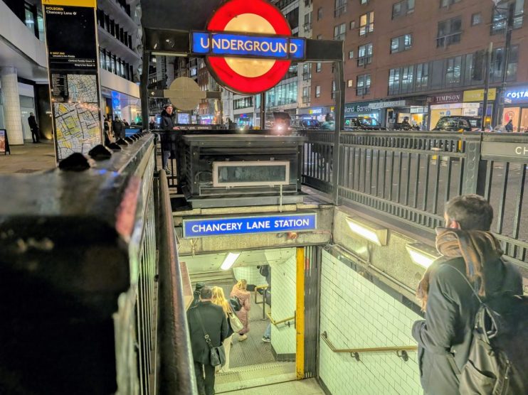 Chancery Lane station entrance, bustling with commuters during peak hours, highlighting Londons vibrant public transport s...