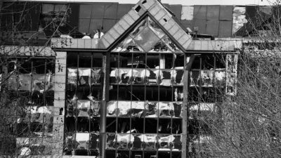 Docklands bomb aftermath showing damaged structures and emergency response teams assessing the scene