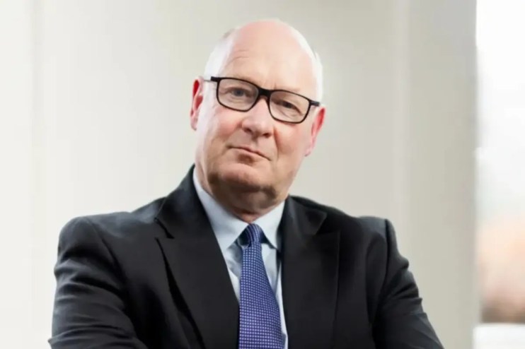 Douglas Flint, prominent business leader, addressing an audience at a corporate event in a formal setting