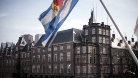 Dutch parliament building with flags and people, symbolizing political discussions, governance, and legislative activities