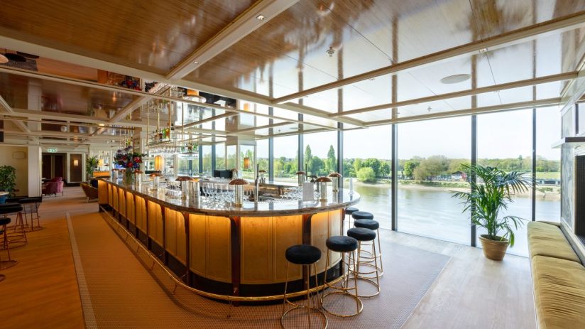 Fulham FC Riverside Stand on a sunny day, showcasing modern architecture and vibrant atmosphere, perfect for football fans